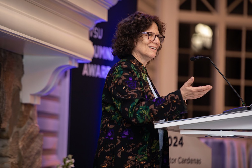 Suzanne Zack reaching out hand as she talks